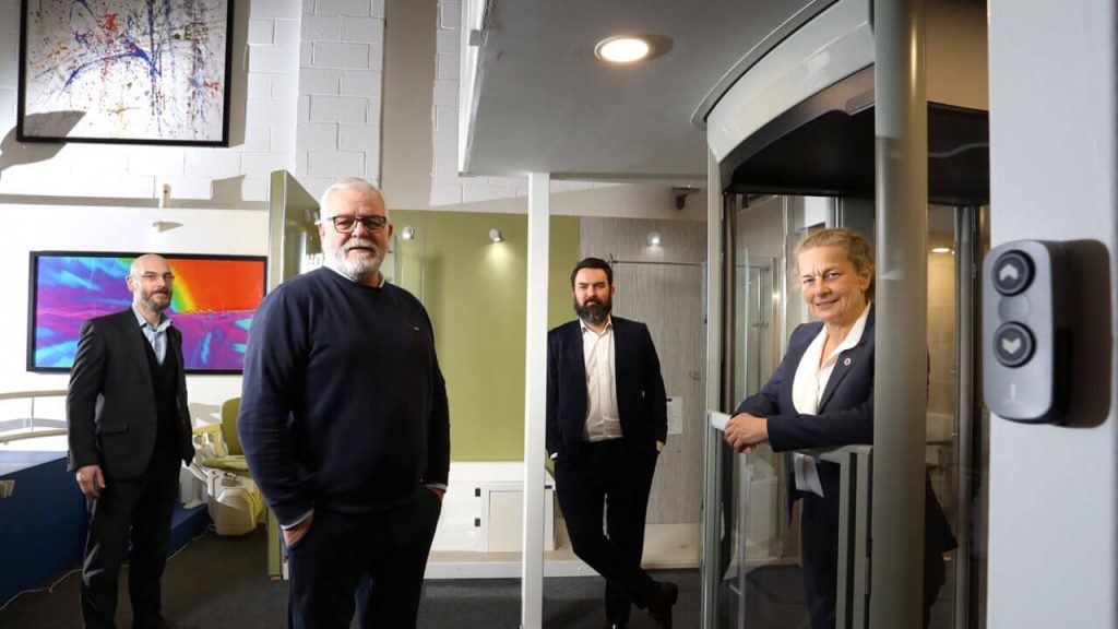 Four people standing in different areas of the RMT office