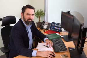 Michael Cantwell sitting at his desk