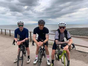 Three people on their bikes posing for a picture