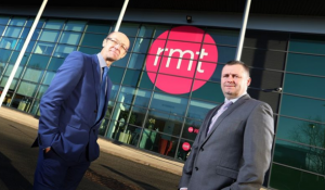 Two members of staff outside the RMT office